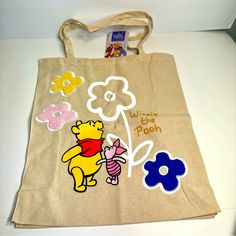 Nwt. Disney Primark Tote Bag. Cute Winnie The Pooh Canvas Tote Bag Approx. 16”H X 14”L. Says Winnie The Pooh With Pooh Bear, Piglet And Some Colorful Flowers. Other Side Of Bag Is Plain. Canvas Double Straps. Perfect For Winnie The Pooh Fans! Disney Yellow School Bag, Yellow Disney School Bag, Disney Yellow Bags For Everyday Use, Winnie The Pooh Canvas, Cute Tote Bag Design, Disney Primark, Painting Tote Bags, Primark Bags, Disney Tote Bags