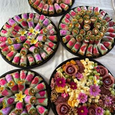 there are many different types of sushi on the trays that have flowers on them