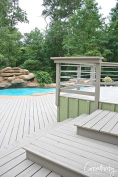 a wooden deck next to a swimming pool