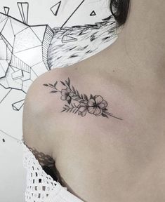 a woman's shoulder with flowers on it and an arrow in the middle of her left arm