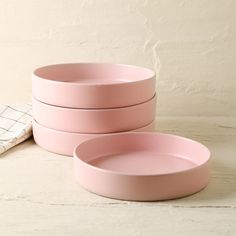 three pink bowls sitting next to each other on a table