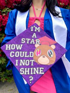 a woman wearing a purple graduation cap with a bear on it that says, i'm a star how could i not shine?