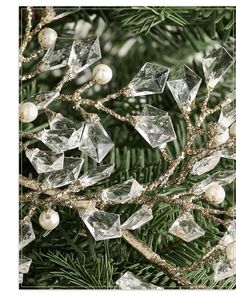 a christmas tree with ornaments hanging from it's branches