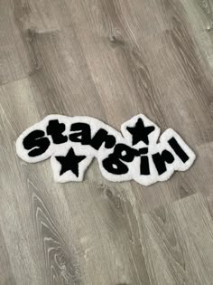 two stars and the word stay in black on a white background with wood flooring