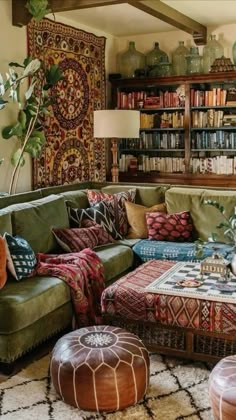 a living room filled with lots of furniture and bookshelves on top of it