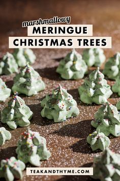 christmas trees made out of meringue and sprinkles on a cookie sheet