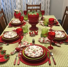 the table is set with red and green dishes