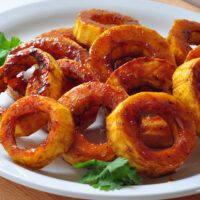 some onion rings are on a white plate