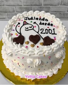 a birthday cake with white frosting and chocolate hearts