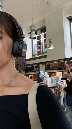 a woman wearing headphones in a store