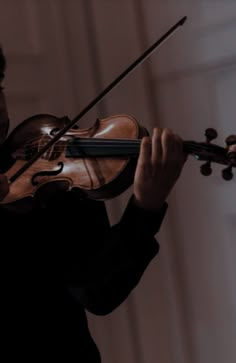 a man holding a violin in his right hand