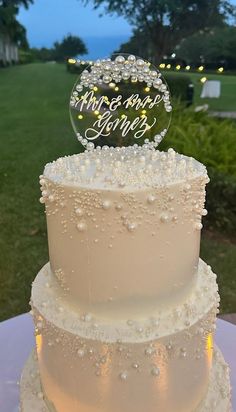 a three tiered wedding cake sitting on top of a table