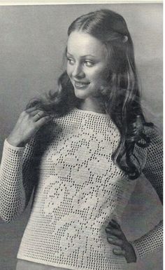 an old photo of a woman wearing a sweater and holding her hands on her hips