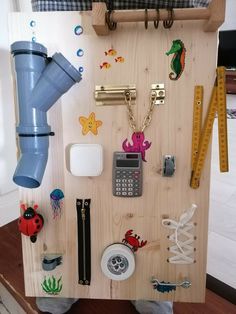 a wooden board with various items attached to it