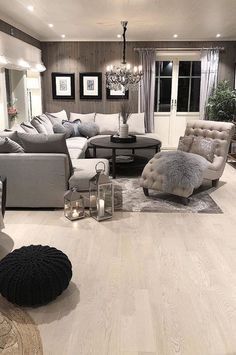 a living room filled with lots of furniture next to a fire place in a fireplace