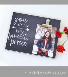 a black and white photo frame with red carnations in front of it that says you are my very favorite person