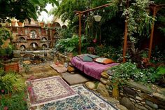 a bed sitting in the middle of a lush green garden