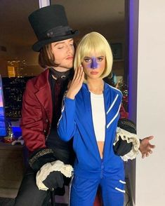 a man and woman dressed up in costumes