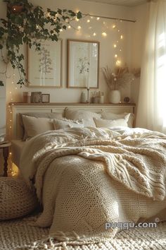 a bed with blankets and pillows in a bedroom next to a window filled with lights