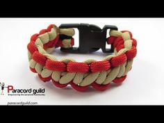 a red, white and black bracelet with an anchor clasp on it's side