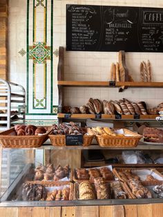 breads and pastries on display in a bakery