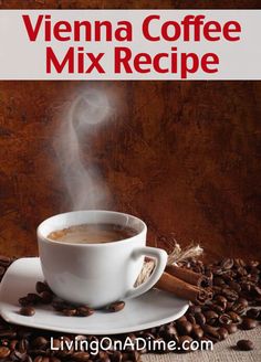 a cup of coffee sitting on top of a white saucer next to some coffee beans