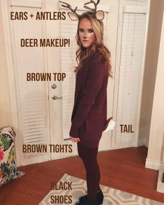 a woman standing in front of a door with deer antlers on it's head