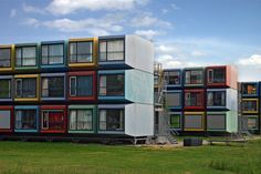 the multi - colored building has many windows and balconies on each floor,