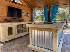 an outdoor entertainment area with wood paneling and glass doors