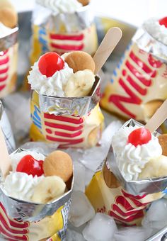 there are many desserts in the ice bucket on the table with red and white stripes