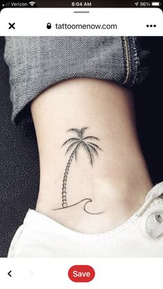 a small palm tree tattoo on the side of a woman's ribcage