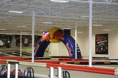 an inflatable red bull is on display at the indoor track course for children