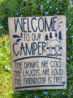 a sign that says welcome to our camper the drinks are cold and the laughs are loud