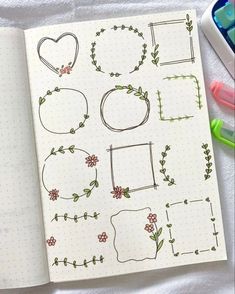 an open notebook with doodles and markers on it