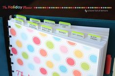 a binder with colorful polka dots on it and the words, the holiday planner