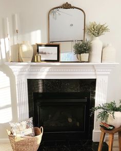 a living room with a fire place and pictures on the mantle