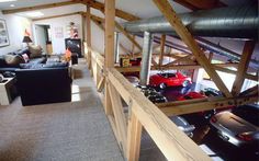 a living room filled with furniture and lots of cars