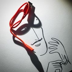 a drawing of a man's face with glasses and a red cord attached to it