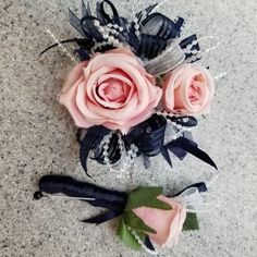 three pink roses are sitting on the floor next to each other, with black ribbons around them