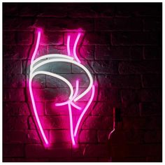 a pink neon sign that is on the side of a brick wall next to a wine bottle