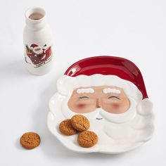 a santa clause plate with cookies next to it