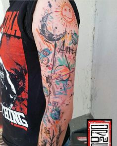 a man's arm covered in colorful tattoos and inking on his left arm