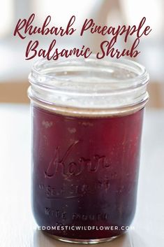 a jar filled with red liquid sitting on top of a table