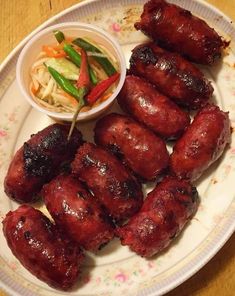 a plate that has some meat on it with a side of coleslaw and slaw