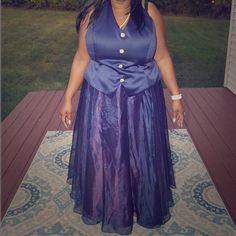 a woman in a purple dress standing on a porch