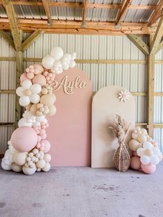 balloons and flowers are arranged on the floor in front of a sign that says,'al