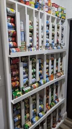 the shelves are full of canned food and cans on them for storage or to display