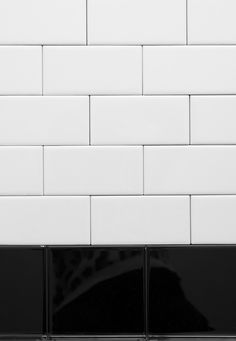 a black and white photo of a tiled wall