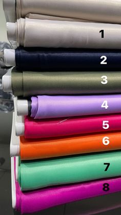 a stack of different colored sheets with numbers on them