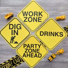 construction signs and caution tape are laid out on the floor next to each other, indicating work zone